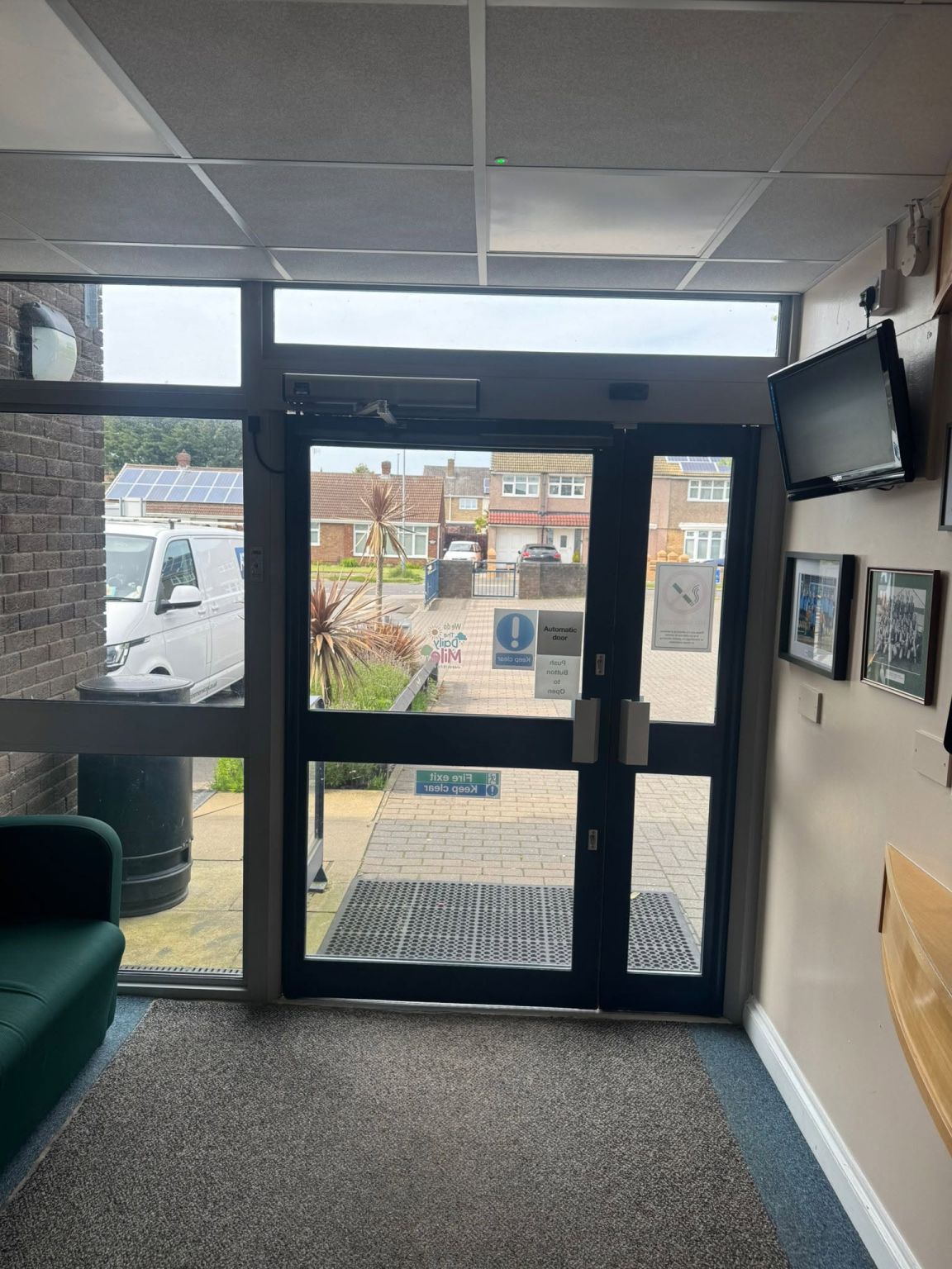 Same entrance with the new surface-mounted swing-door operator and transom